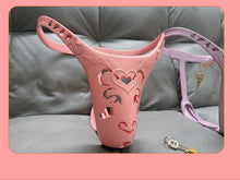 Load image into Gallery viewer, Pink heart-cutout chastity belt photographed with a purple belt and keys
