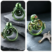 Load image into Gallery viewer, Front, back, and angled views of the Abyssal Eye Alloy Chastity Cage with two included keys
